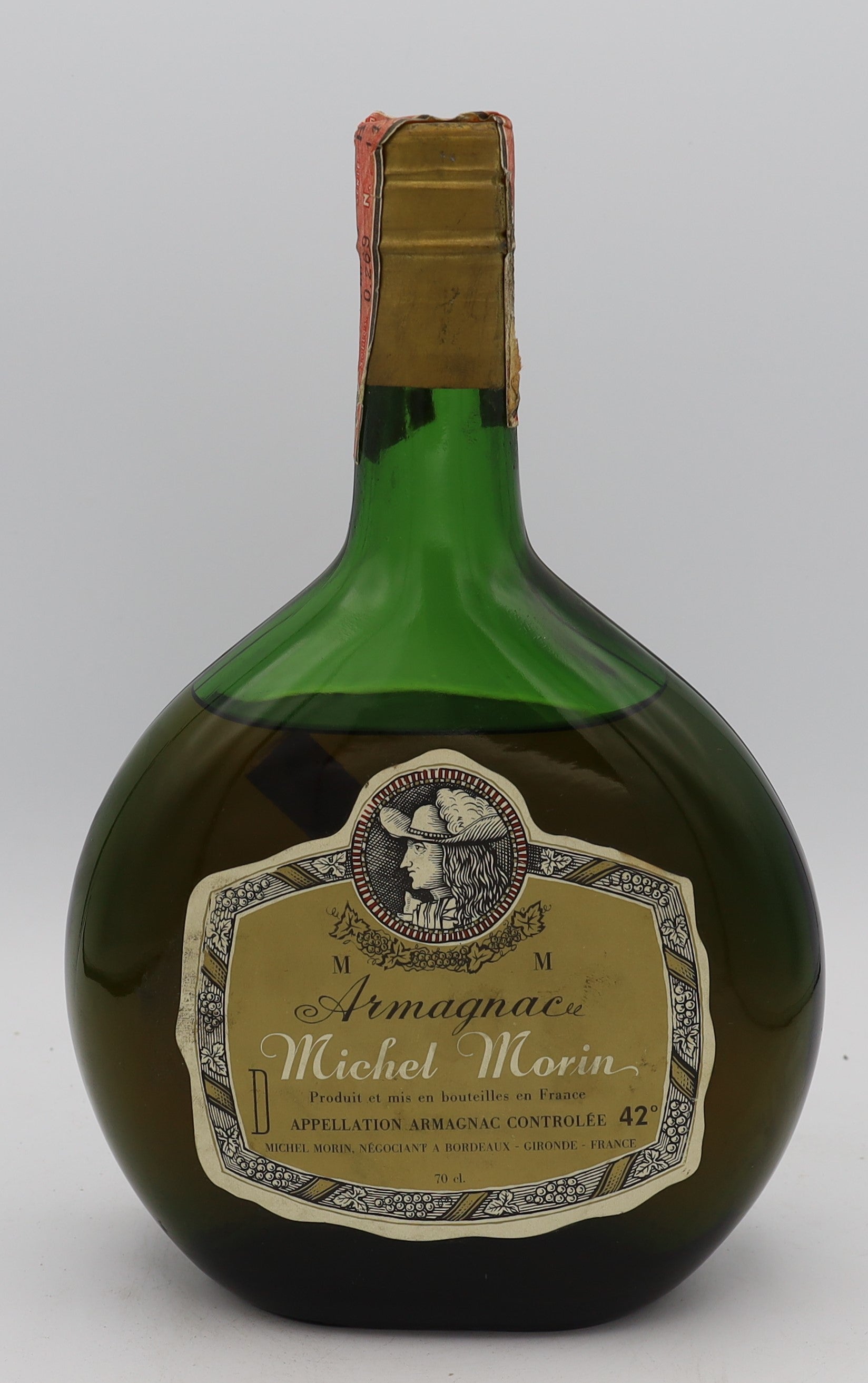 Michel Morin Armagnac with gold cap in green bottle – premium aged brandy with rich, complex flavors, presented in an elegant collector’s bottle.